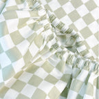 Sage checker fitted sheet on bed
